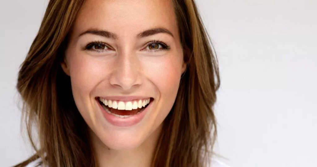 Smiling person showcasing porcelain veneers